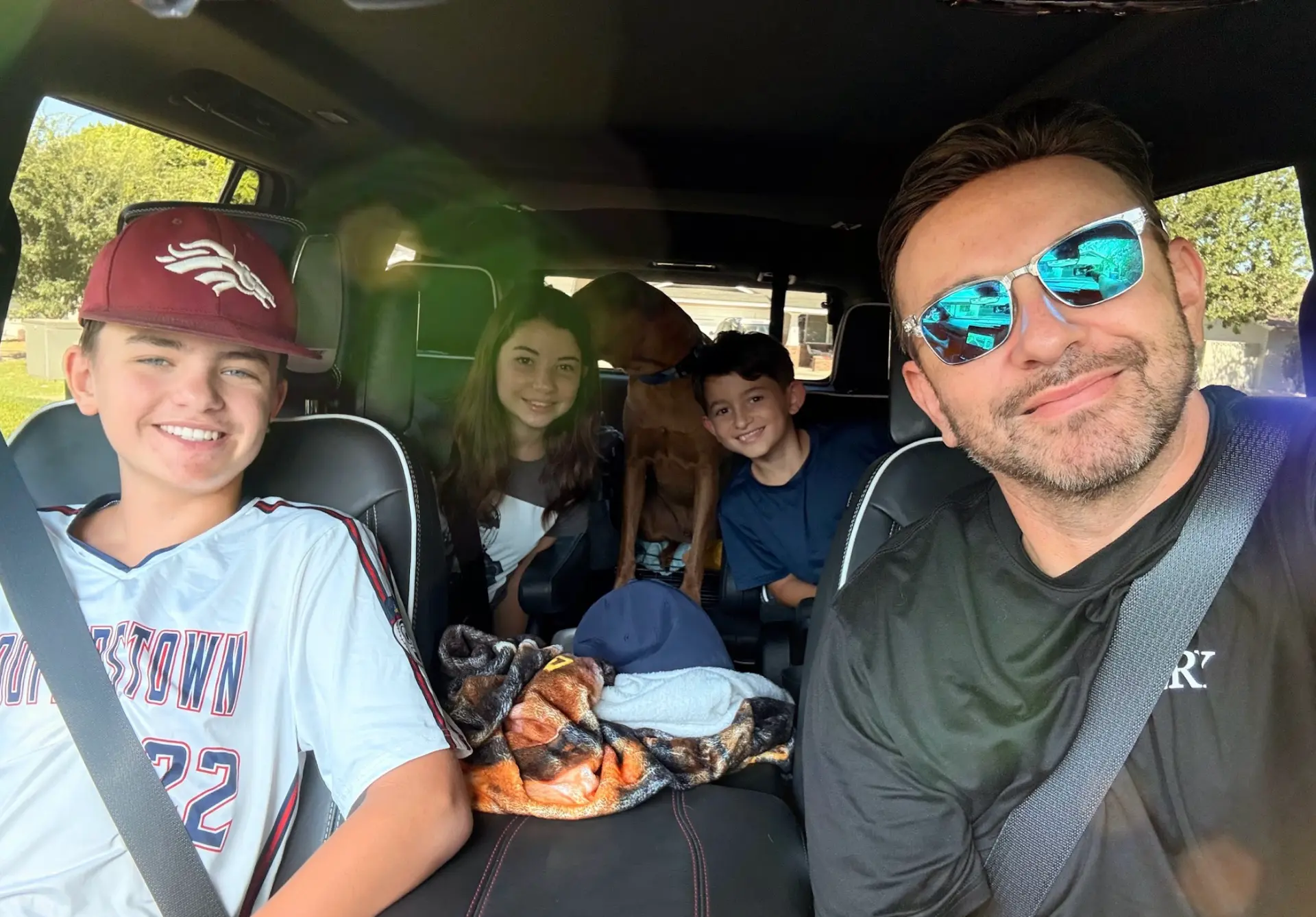 Scott Salkin driving with his three kids and the family dog in the car
